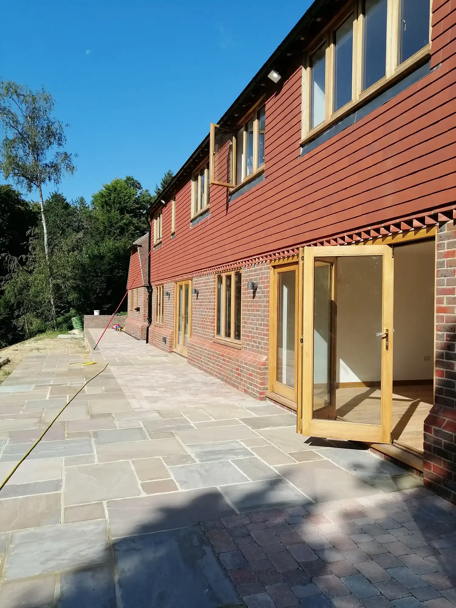 house with patio and wooden external doors