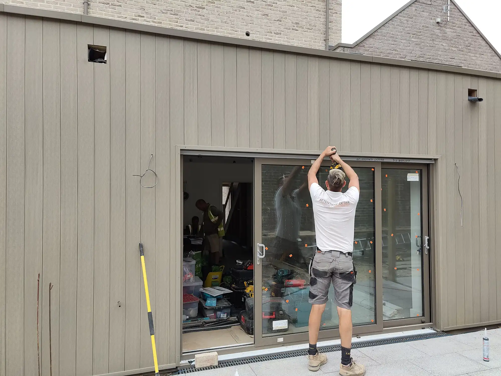 man working on cladded extension