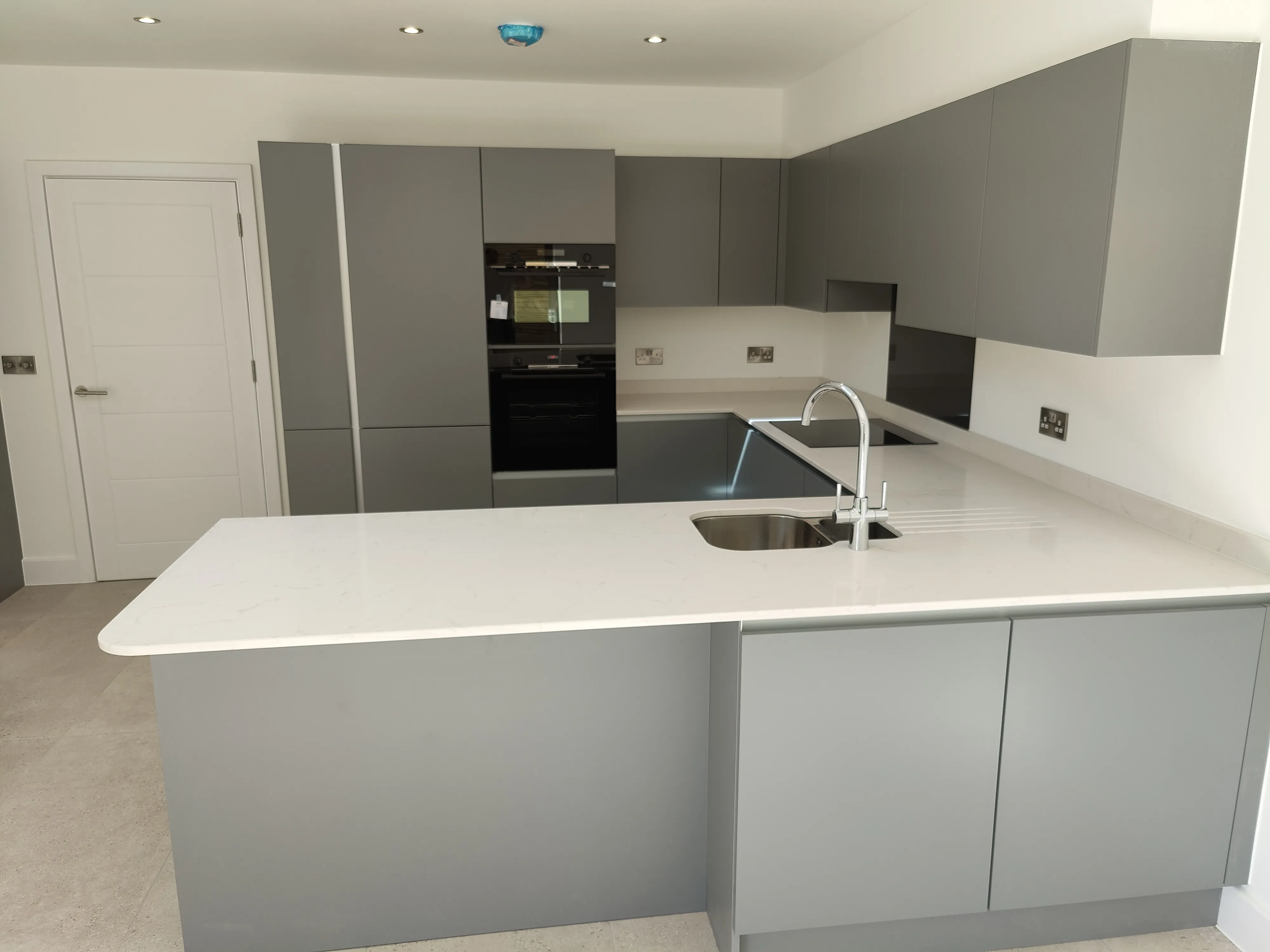 new grey kitchen units and mixer tap