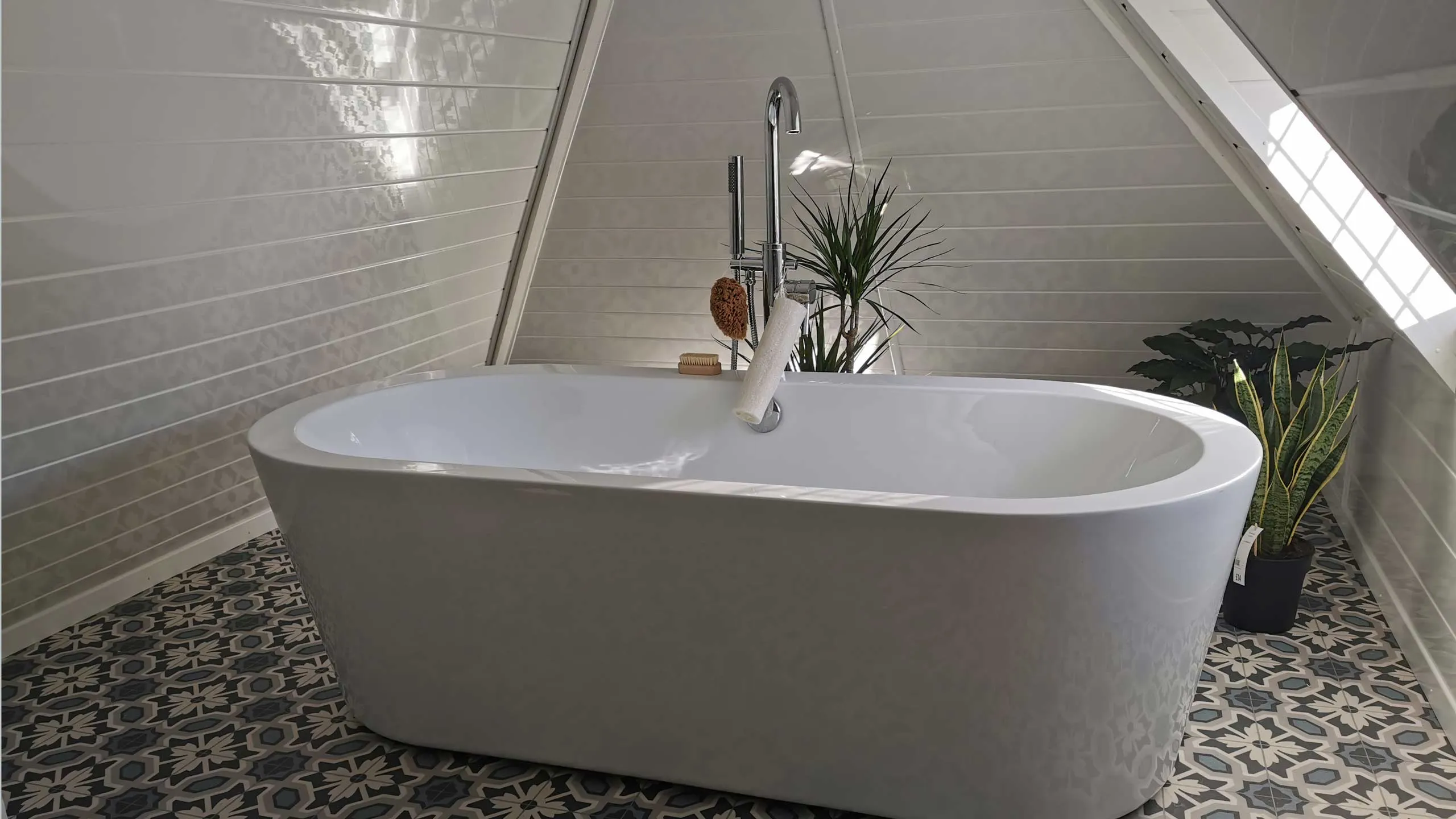 white bath with patterned floor