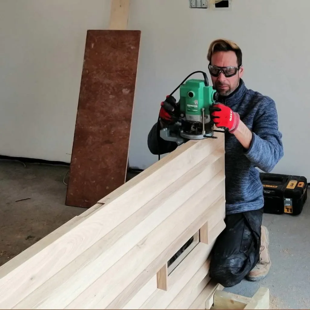 man planing a wooden door